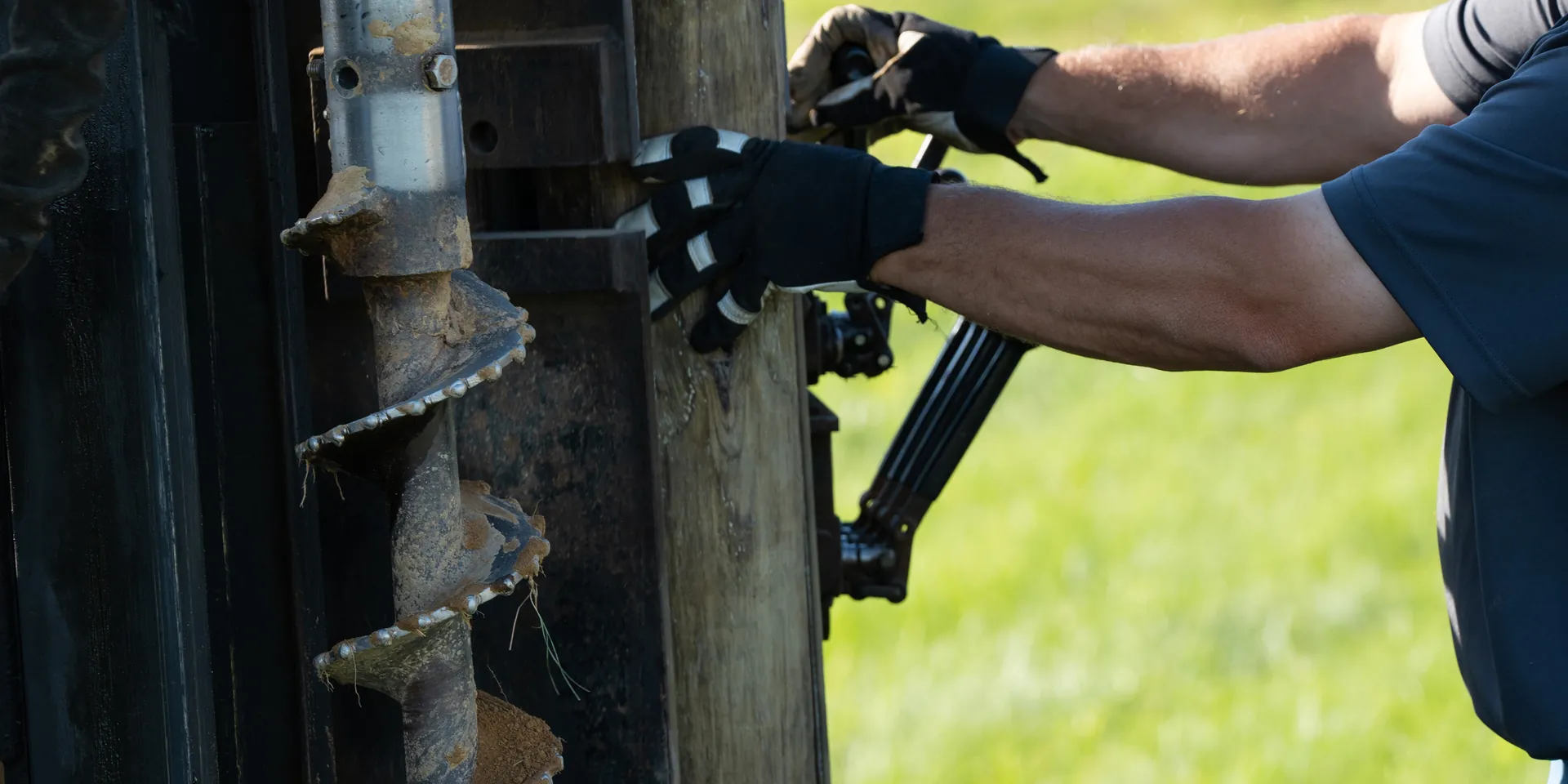 Doughty Fence Builders team member working with fencing equipment