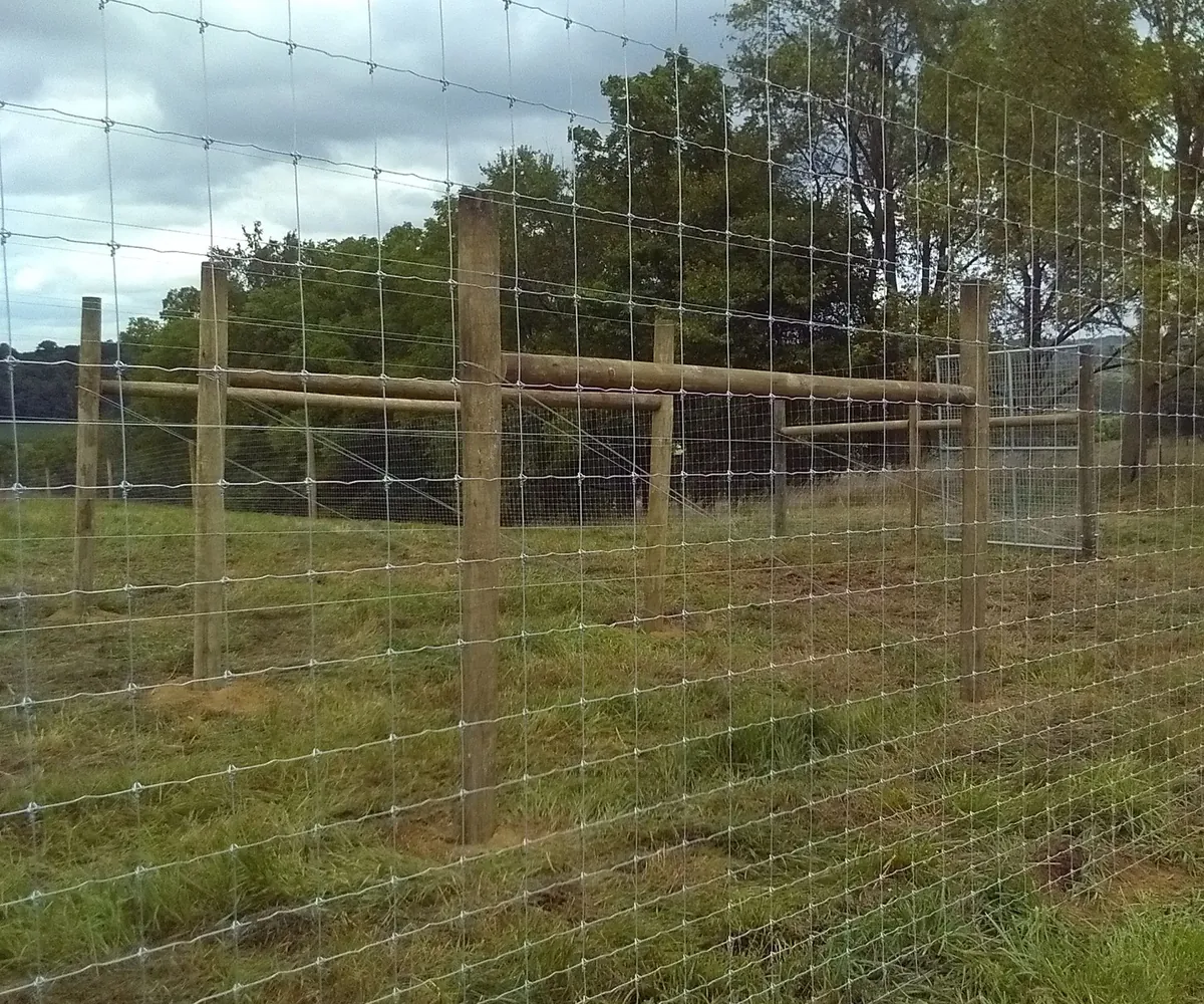 Stay-Tuff woven wire fence installed on a rural property
